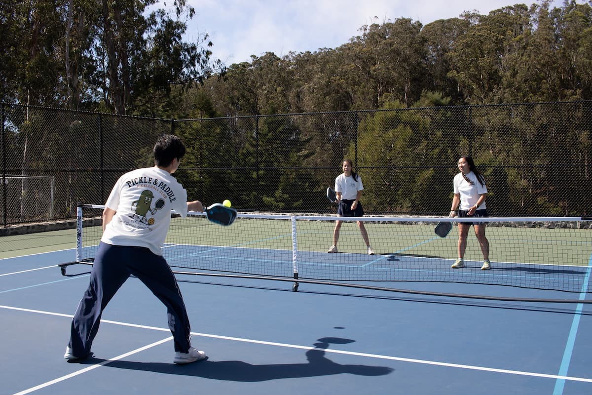 A doubles rally at the net during open play